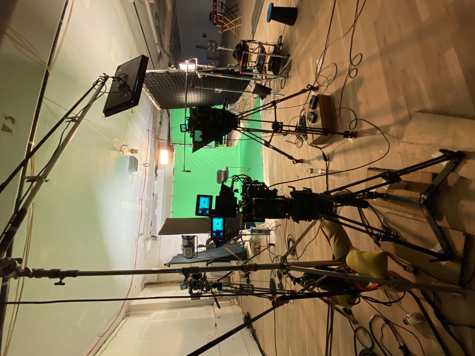 behind the C300s on tripods aimed at the green screen