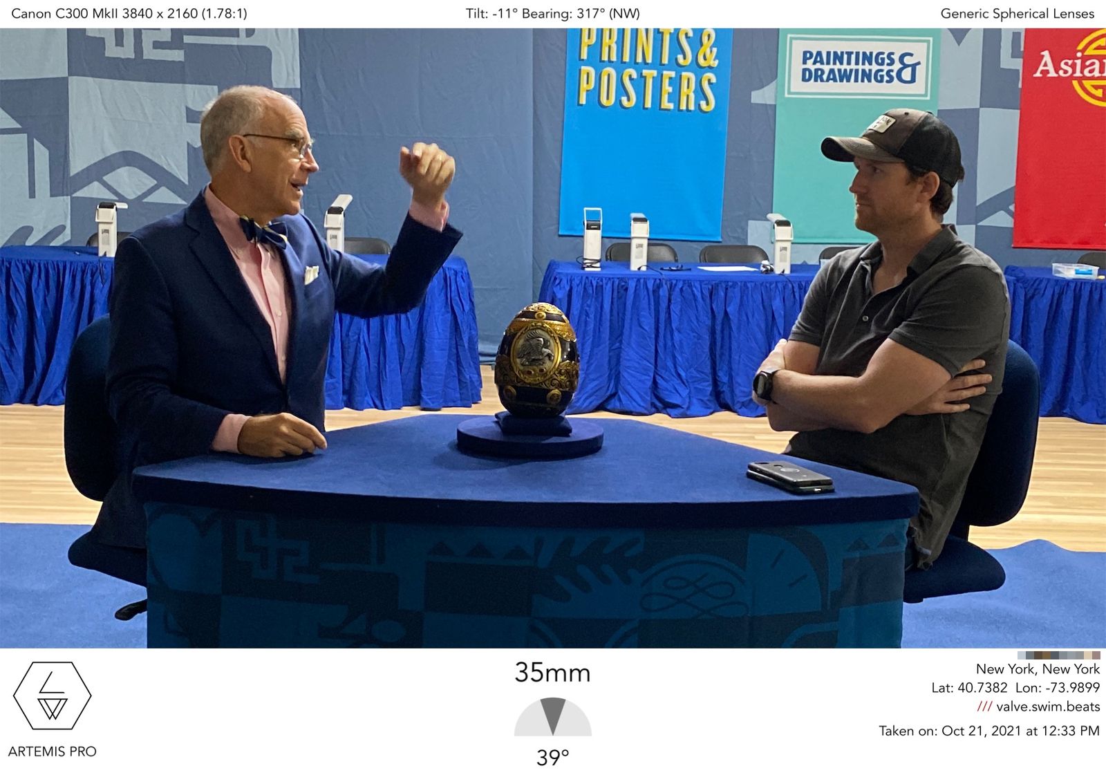 appraiser in bow tie with the egg, Ryan Reynolds listening (Artemis scout frame)